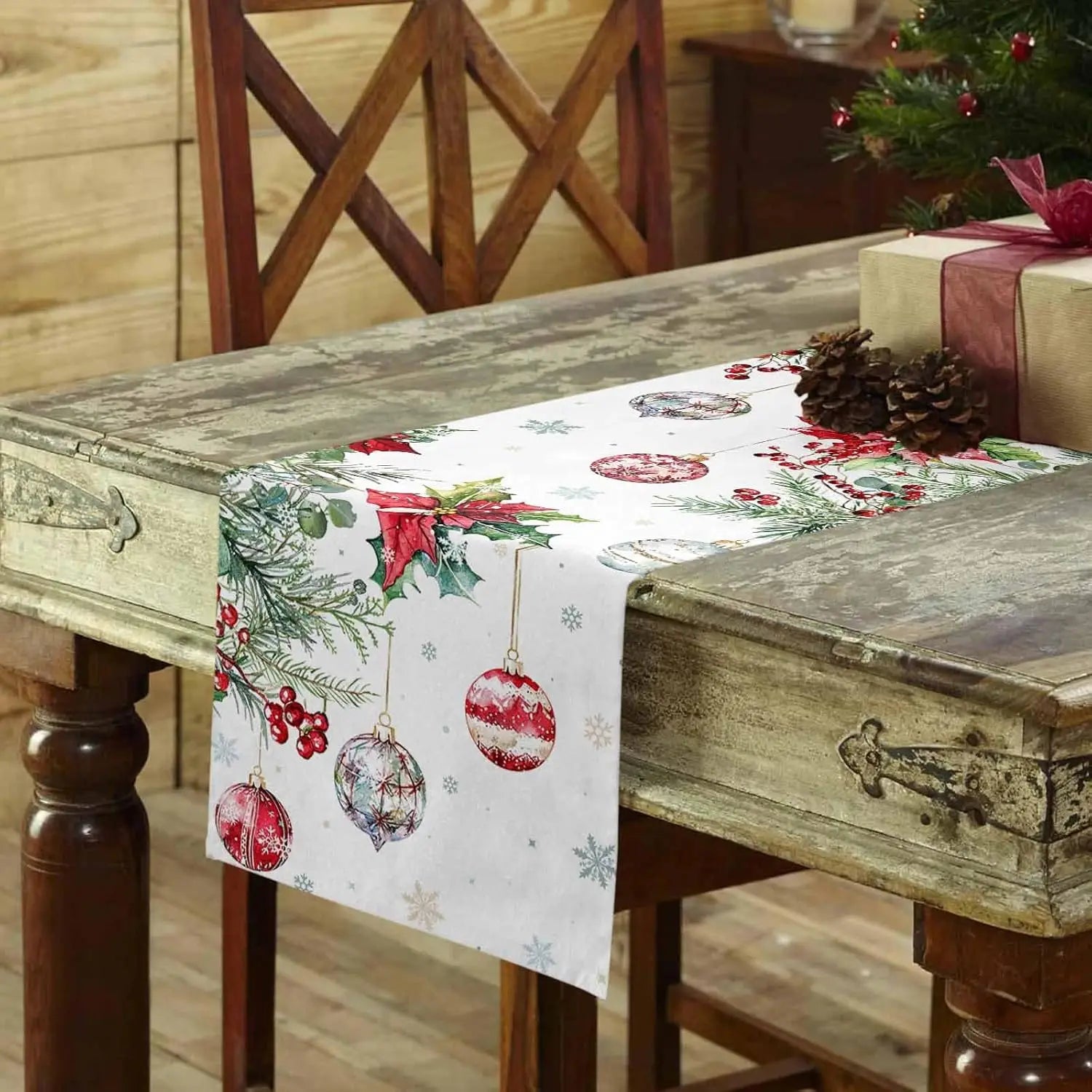 Christmas Poinsettia Linen Table Runner with Festive Ornaments and Holiday Decor on a Rustic Wooden Table