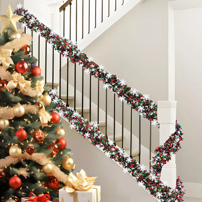Christmas snowflake tinsel garland adorning a festive staircase with a decorated Christmas tree