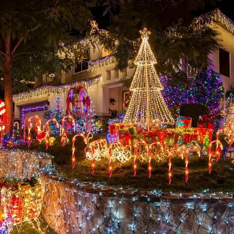 Festive Christmas solar candy cane lights illuminating a cheerful holiday display in a decorated yard
