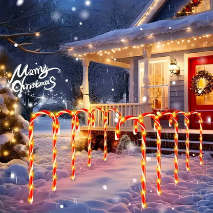 Festive Christmas solar candy cane lights illuminating a snowy porch with holiday decorations