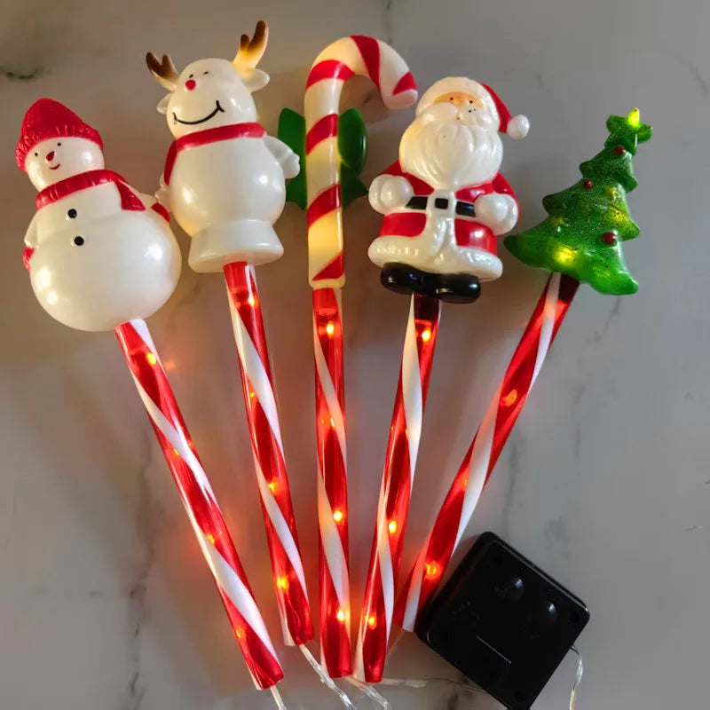 Christmas solar lawn lights set featuring snowman, reindeer, Santa, candy cane, and Christmas tree designs