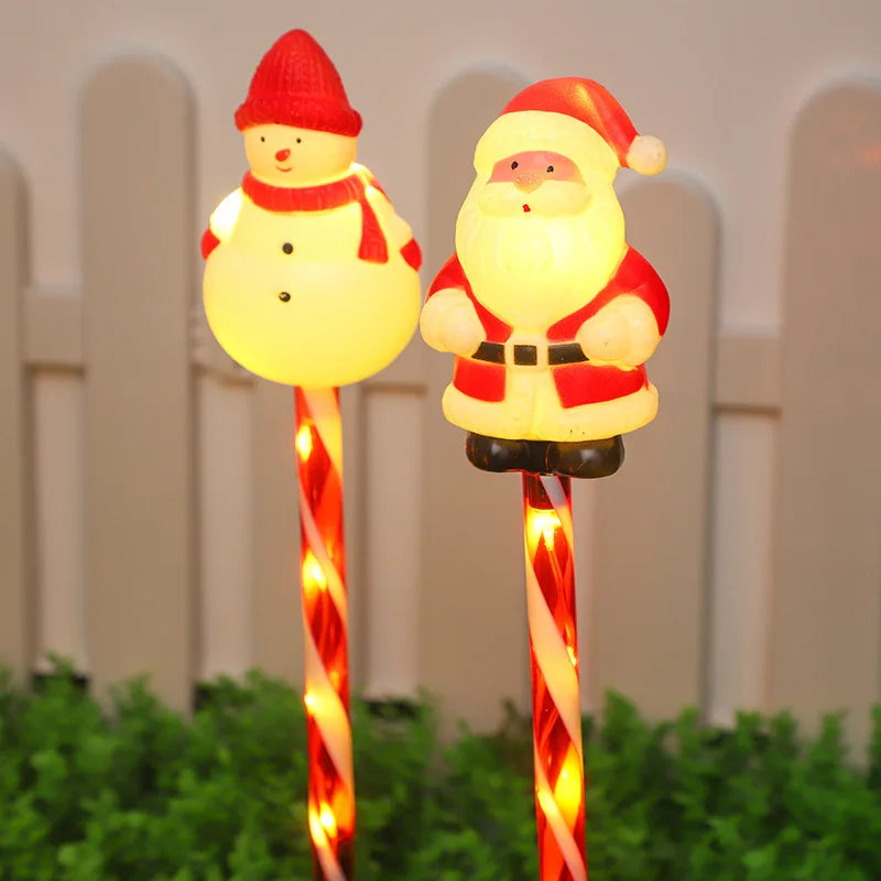 Christmas solar lawn lights set featuring Santa and snowman decorations on striped stakes