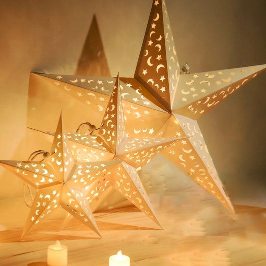 Nutshell Christmas star paper lanterns in various sizes with intricate cut-out designs and warm light