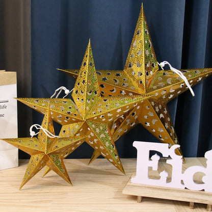 Gold Christmas star paper lanterns in various sizes, perfect for festive home decor