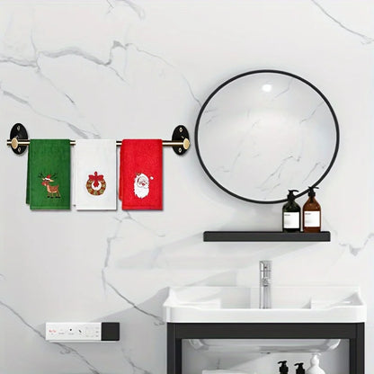 Christmas themed hand towels in red and green featuring Santa and a reindeer on a stylish bathroom rack