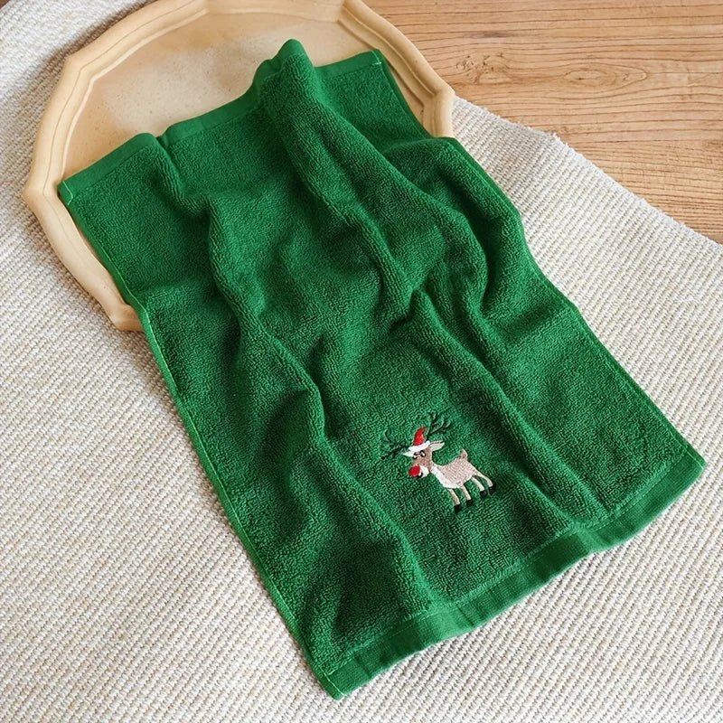 Christmas themed hand towels in green featuring a reindeer design for festive kitchen decor