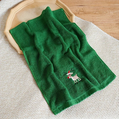 Christmas themed hand towels in green featuring a reindeer design for festive kitchen decor