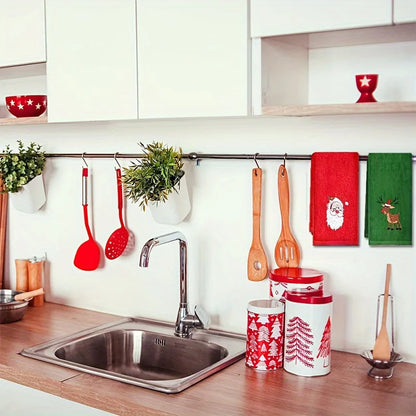 Christmas themed hand towels displayed in a festive kitchen with red and green designs
