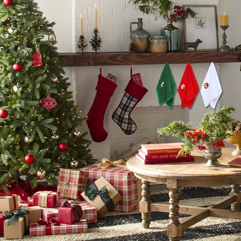 Decorative display of Christmas themed hand towels hanging near a Christmas tree and gifts
