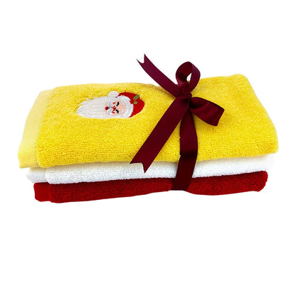 Set of Christmas themed hand towels in yellow, white, and red with a Santa design and ribbon decoration