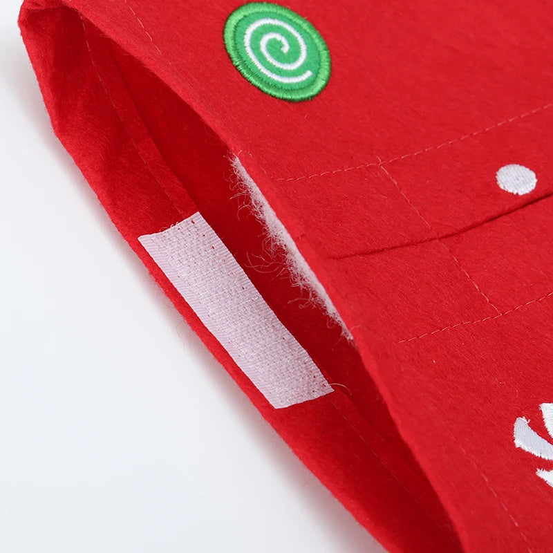 Red Christmas tissue box cover featuring festive design and bright green swirl accents