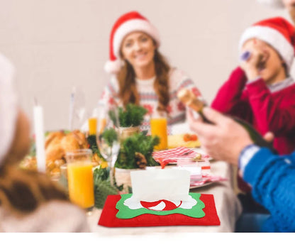Christmas tissue box cover featuring festive red and green design on a holiday dining table