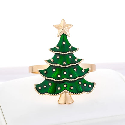 Elegant Christmas tree napkin rings in gold with green enamel and star accents for festive dining