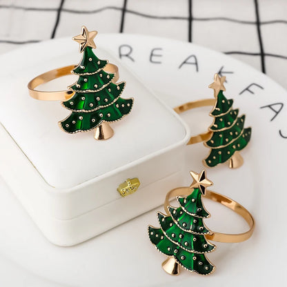 Nutshell Christmas tree napkin rings in green with gold accents for festive holiday table settings