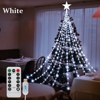 Christmas tree shooting star lights illuminating a decorated tree with a star on top