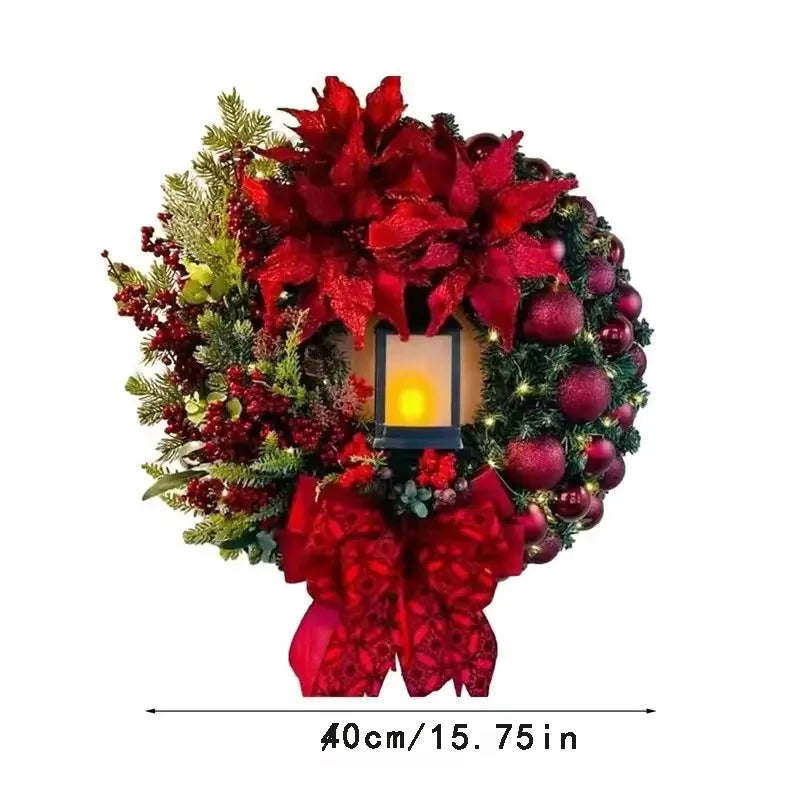 Festive Christmas Wreath With Lantern featuring red flowers, ornaments, and a decorative bow