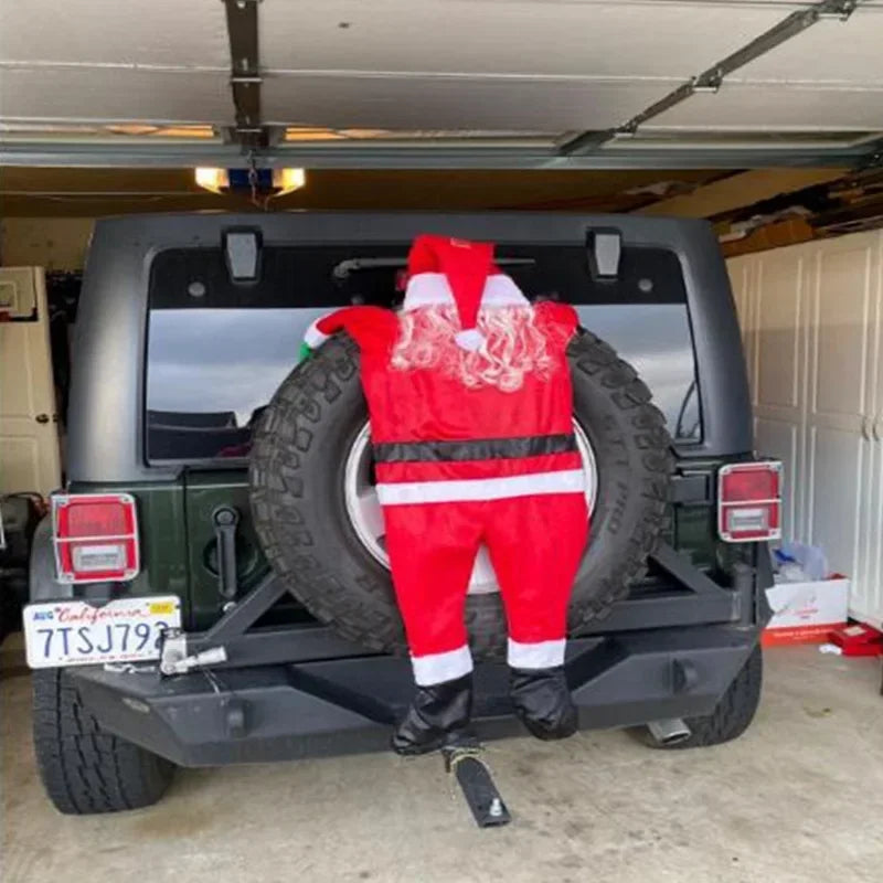 Climbing Santa Claus decoration on a Jeep spare tire for festive holiday cheer