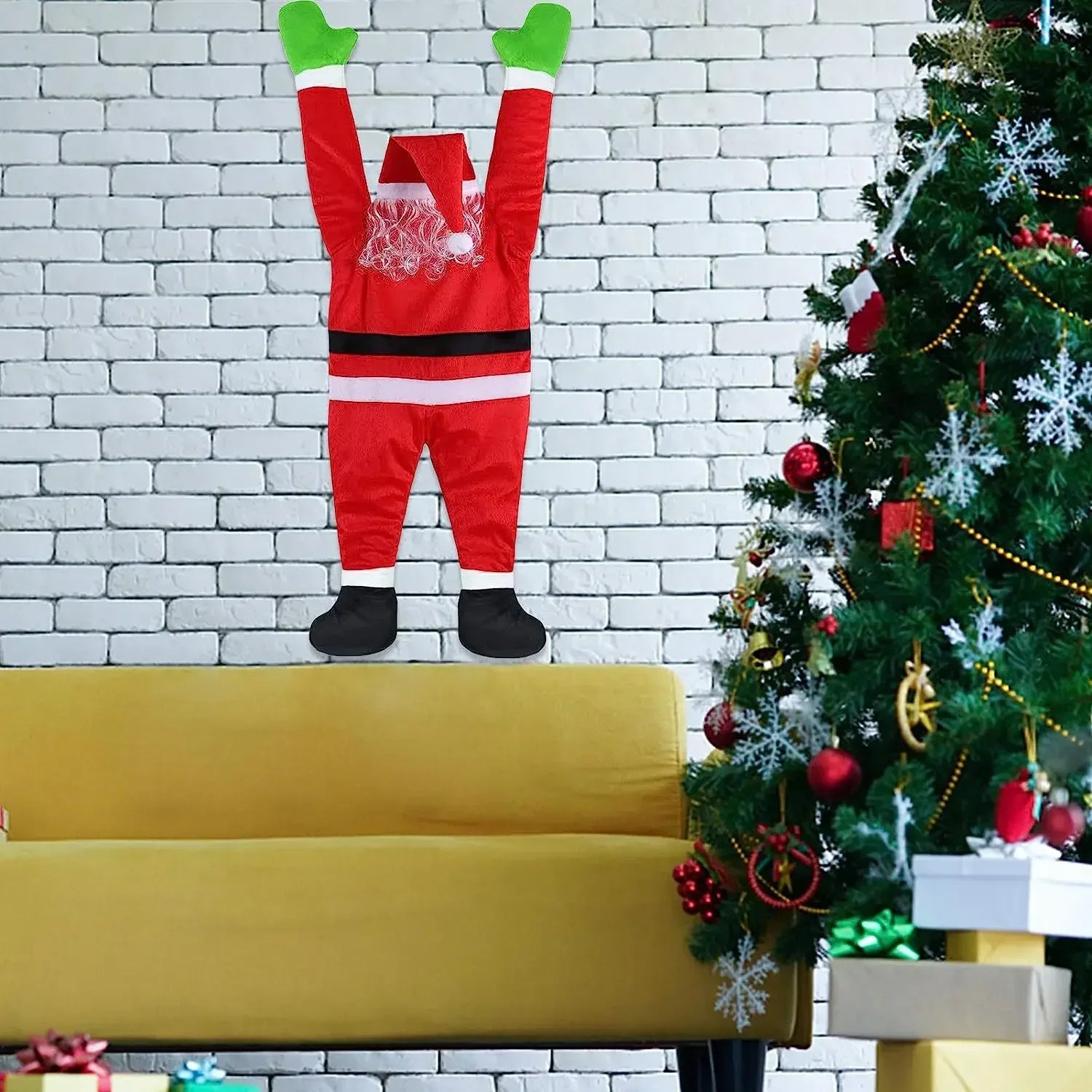 Climbing Santa Claus decoration mounted on a wall with festive holiday decor nearby