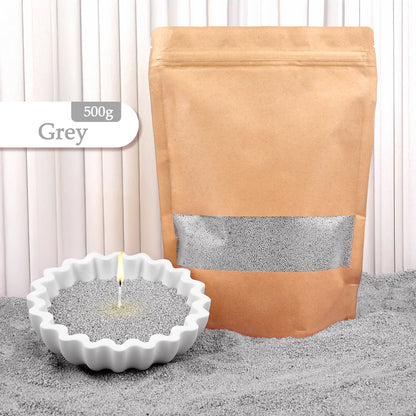 Nutshell grey colored candle sand 500g with lit candle in white fluted dish