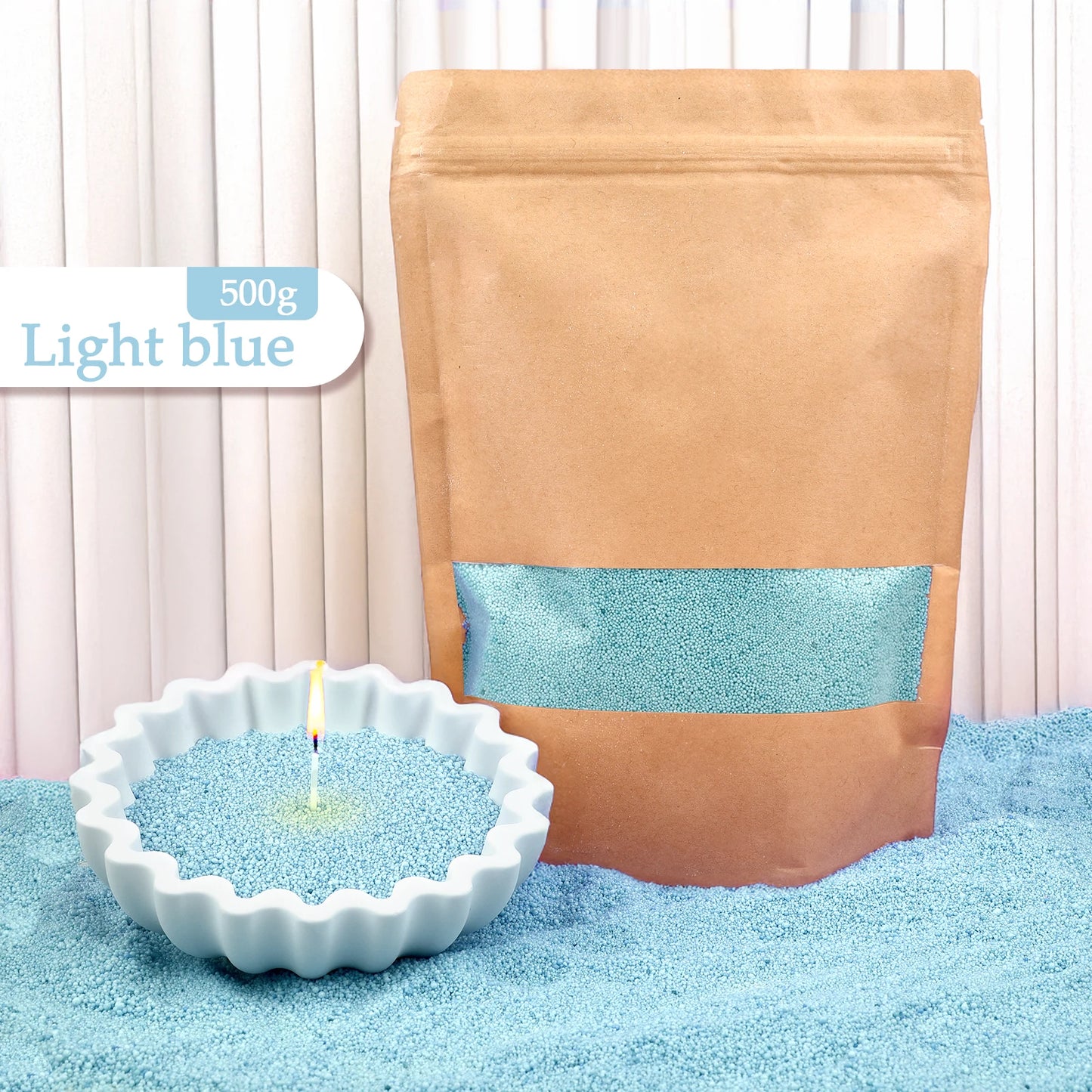 Nutshell light blue colored candle sand 500g pack with candle burning in blue sand
