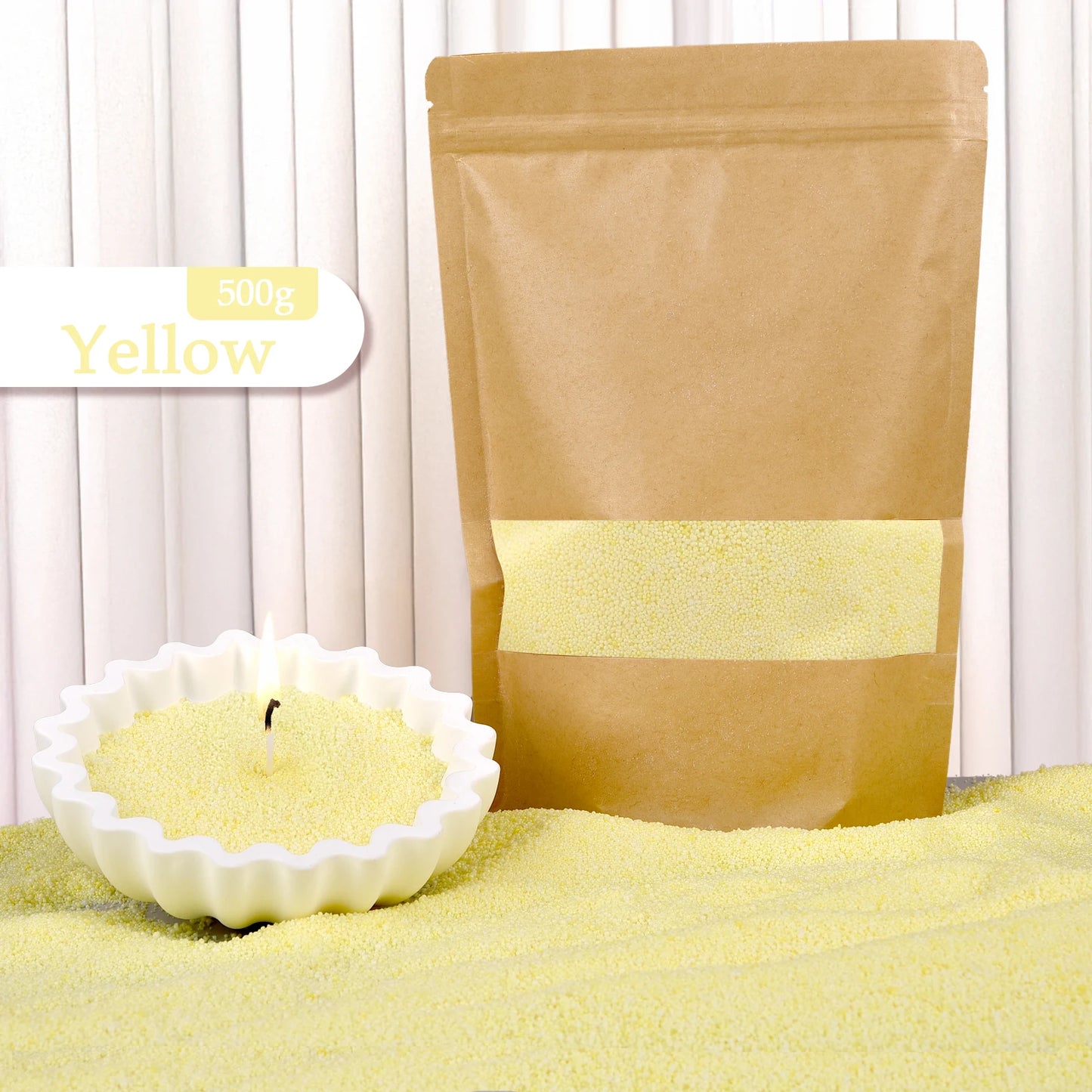 Yellow colored candle sand by Nutshell in 500g kraft pouch with candle in white dish