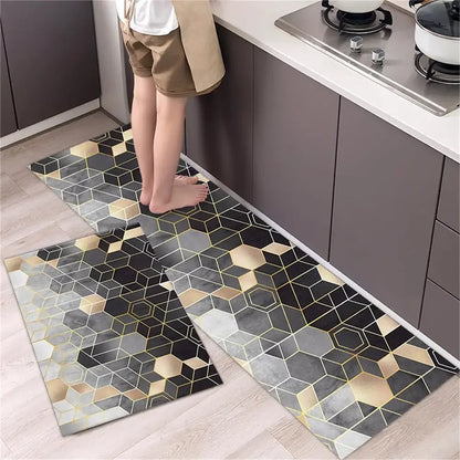 Nutshell Anti Slip Kitchen Floor Mat set two piece geometric hexagon design in black gray and gold placed by kitchen sink with feet