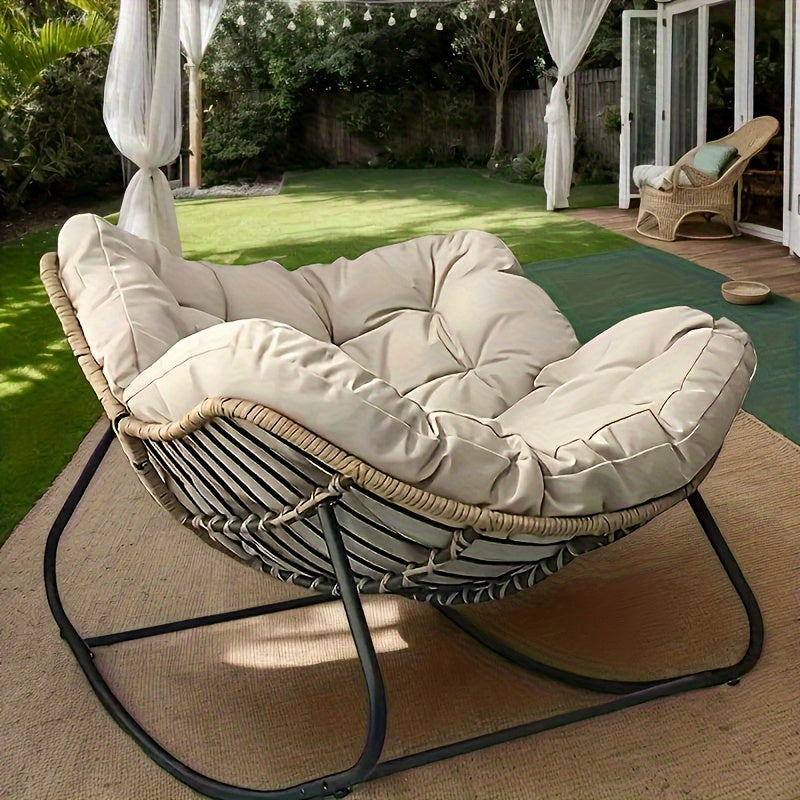 Nutshell beige tufted comfortable patio chair cushion on wicker lounger with metal frame in backyard