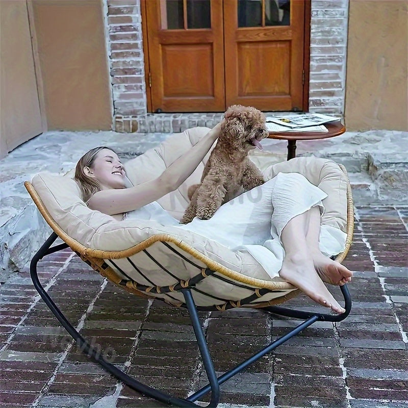 Nutshell comfortable patio chair cushion in round papasan lounger with woman relaxing and dog
