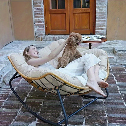 Nutshell comfortable patio chair cushion in round papasan lounger with woman relaxing and dog