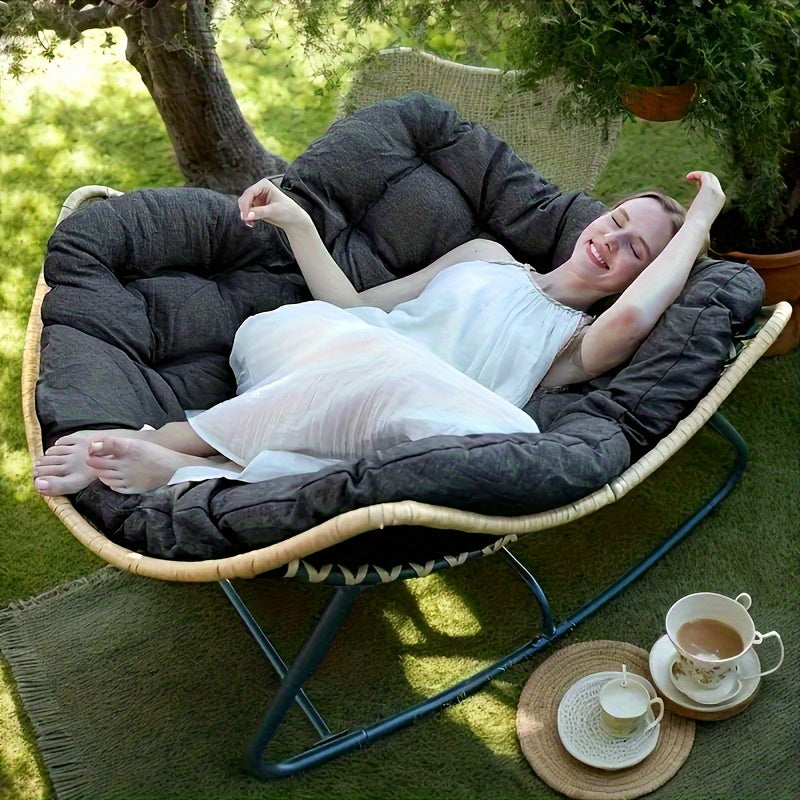 Nutshell comfortable patio chair cushion dark gray on woven lounger with woman reclining outdoors