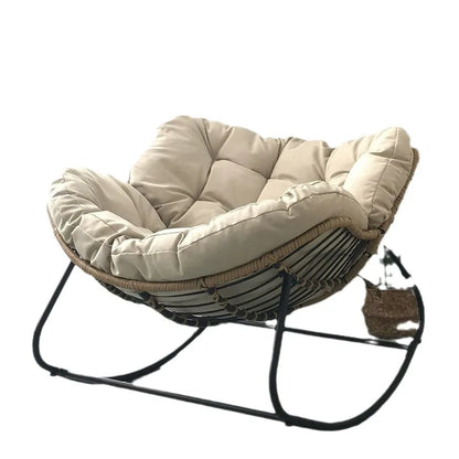 Nutshell lazy leisure rocking chair with cushion cream tufted seat rattan frame and black metal rocker