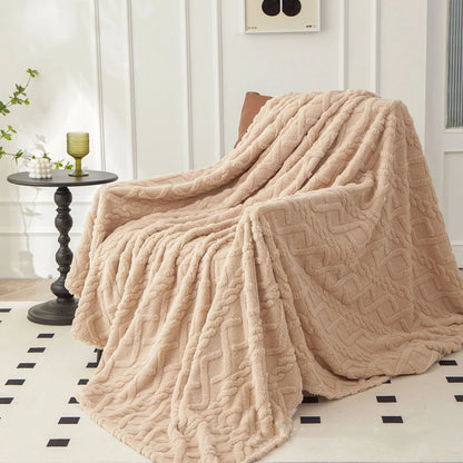 Nutshell warm sofa throw blanket beige plush cable knit draped over armchair in living room