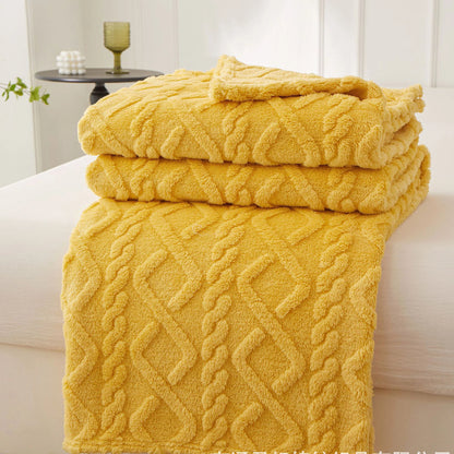 Nutshell warm sofa throw blanket in mustard yellow cable knit plush folded on a couch for cozy living rooms