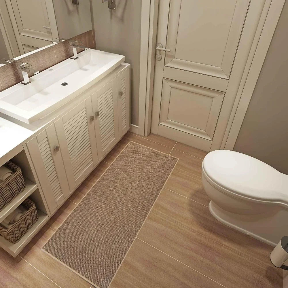 Nutshell washable non-slip kitchen rug beige runner in bathroom by sink and toilet on wood tile floor