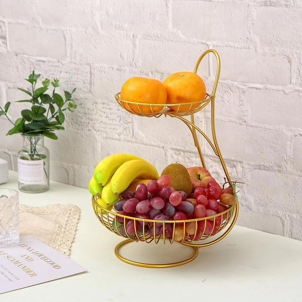 Nutshell decorative fruit storage rack with two-tier gold metal design holding bananas, grapes, persimmons, and apples