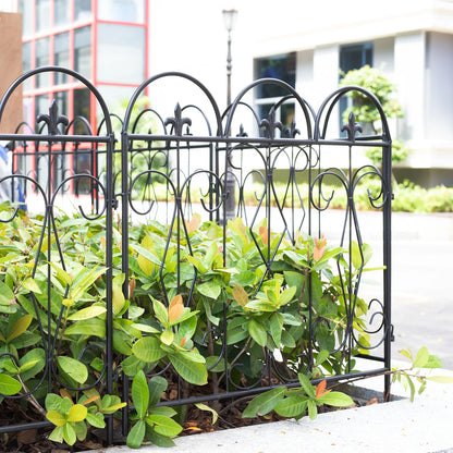 Nutshell black decorative garden fence panels with intricate metal design surrounding green plants