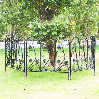 Nutshell black decorative garden fence panels with floral and leaf designs surrounding a tree