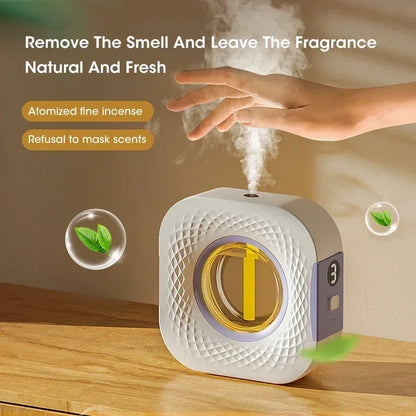 Nutshell desktop aroma diffuser releasing fine mist with hand above, ideal for fresh natural home fragrance