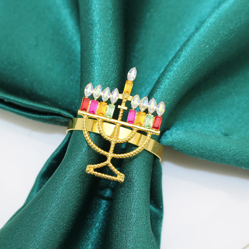 Gold Christmas napkin rings set with colorful gemstone accents for festive table settings