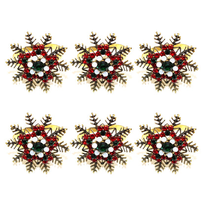 Christmas napkin rings set featuring snowflake designs embellished with red and green decorations