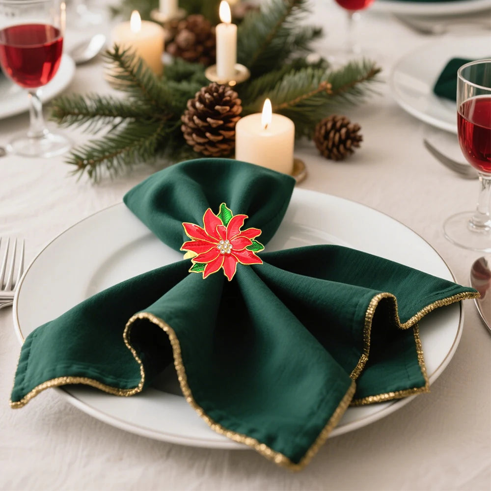 Christmas Red Poinsettia Napkin Rings on Elegant Table Setting with Green Napkin and Candles