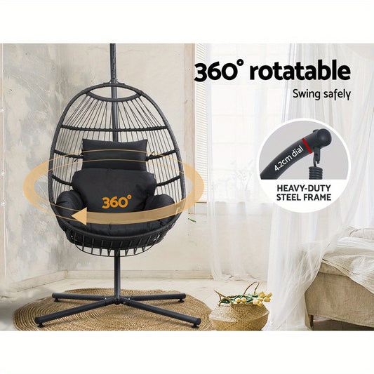 Black egg swing chair with stand featuring 360 degree rotatable heavy-duty steel frame in cozy indoor setting