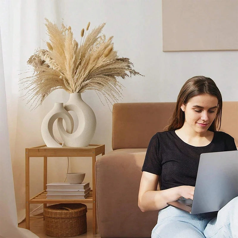 European style white plastic vase set with decorative dried flowers in a cozy modern living room