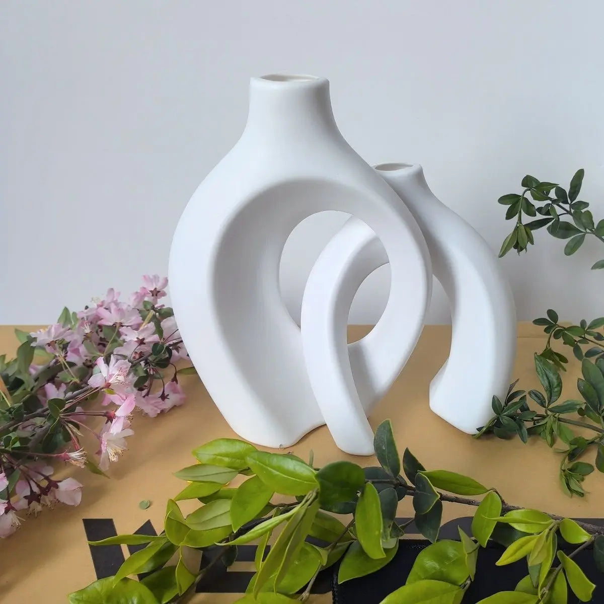 European style white plastic vase set with modern curved design and greenery accents
