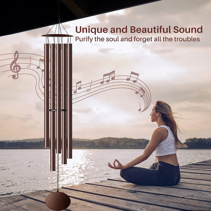 Extra large aluminium chimes outdoor creating a peaceful sound by the lake with a person meditating