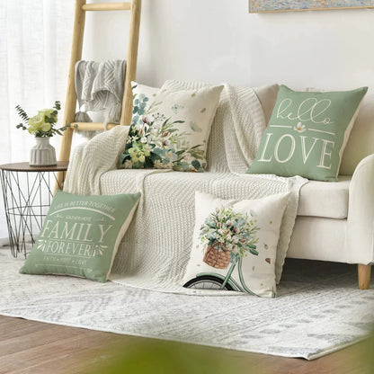 Farmhouse eucalyptus pillow covers on decorative cushions arranged on white sofa with knitted throw