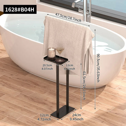 Floor standing towel rack with shelf in modern bathroom setting, featuring soft towel and decorative items