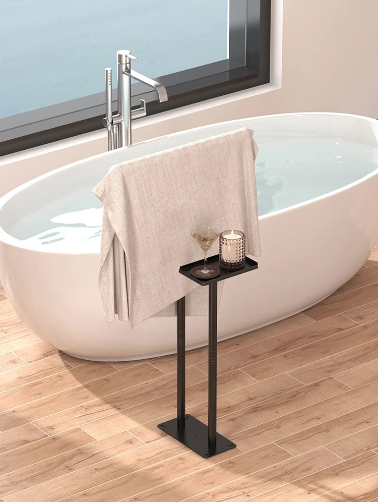 Modern floor standing towel rack with shelf next to a stylish bathtub for convenient storage