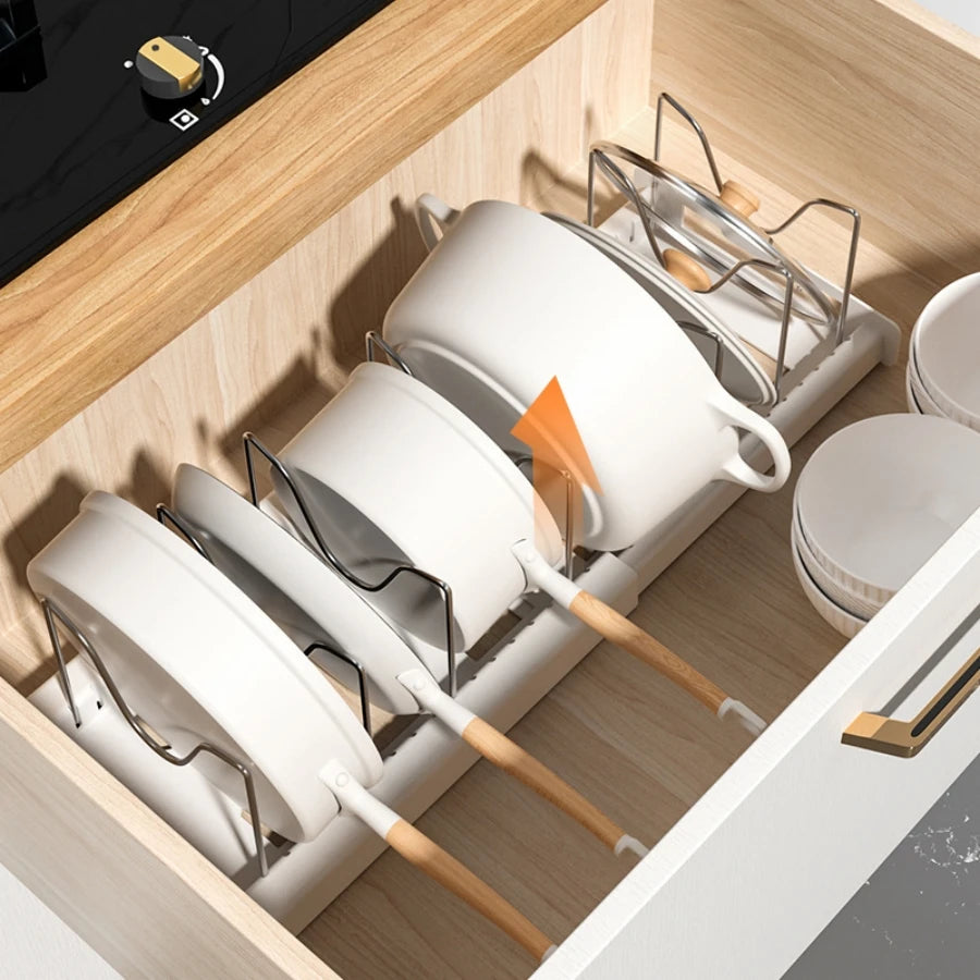 Nutshell foldable pot and lid organizer in a kitchen drawer holding pots and lids neatly