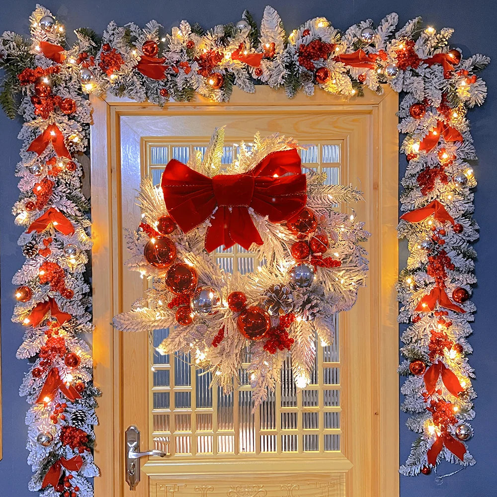 Festive front door Christmas garland decorations with red bows, ornaments, and twinkling lights